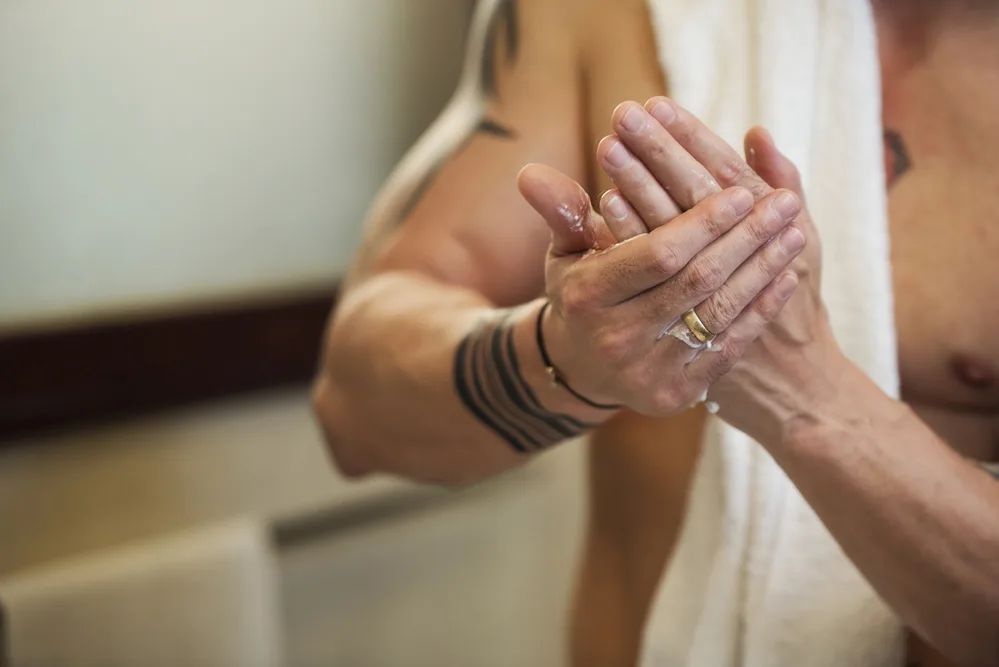 woman moisturizing hand with organic lotion